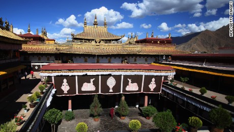 LHASA, CHINA - JUNE 18: A Tibetan Buddhist monk walks into the Jokhang Temple on June 18, 2009 in Lhasa, Tibet Autonomous Region, China. Traditionally, Lhasa is the seat of the Dalai Lama and the capital of Tibet, and is the highest capital in the world. (Photo by Feng Li/Getty Images) 