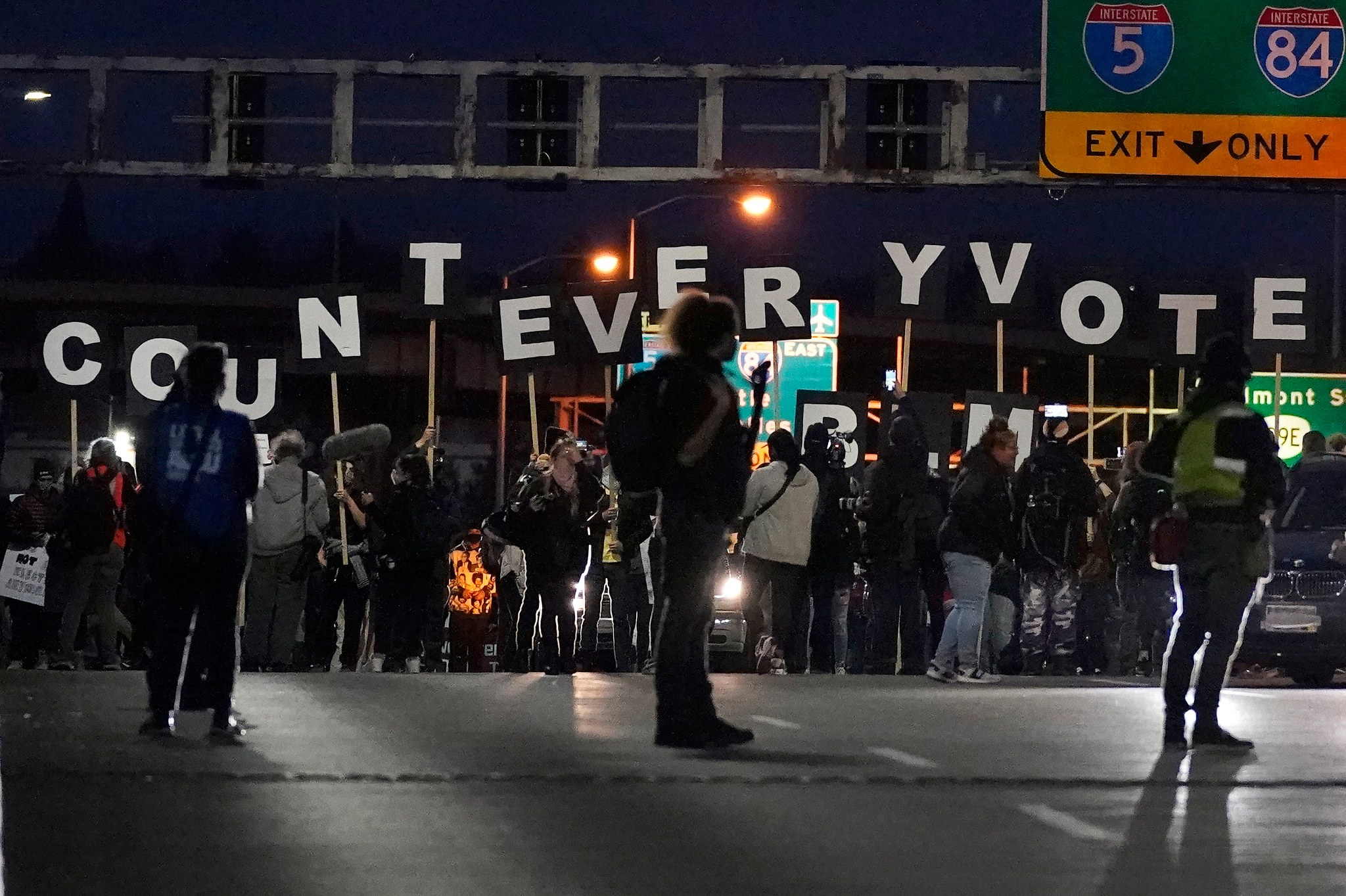 Protesters hold letters that spell Count Every Vote as they cross an overpass while marching in Portland on Wednesday, Nov. 4, 2020.