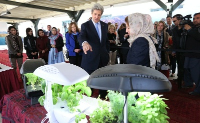 Hassina Syed, owner of the Syed Companies, explains one of her product lines, hydroponic plants, to Secretary John Kerry during a women's business showcase held at the U.S. Embassy on Tuesday, in Kabul. Her other business lines also include trucking, solar lighting and hospitality. 