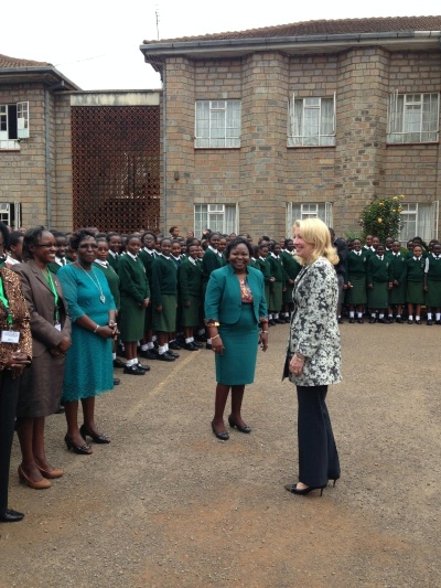U.S. Ambassador for Global Women's Issues Cathy Russell is greeted by faculty and students at the Alliance Girls' High School in Kenya, July 23, 2015.