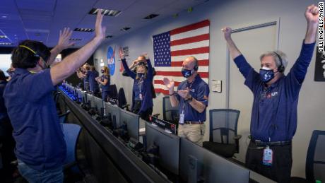 Members of NASA&#39;s Perseverance rover team react in mission control after receiving confirmation the spacecraft successfully touched down on Mars, Thursday, Feb. 18, 2021, at NASA&#39;s Jet Propulsion Laboratory in Pasadena, California. A key objective for Perseverance&#39;s mission on Mars is astrobiology, including the search for signs of ancient microbial life. The rover will characterize the planet&#39;s geology and past climate, pave the way for human exploration of the Red Planet, and be the first mission to collect and cache Martian rock and regolith. Photo Credit: (NASA/Bill Ingalls)