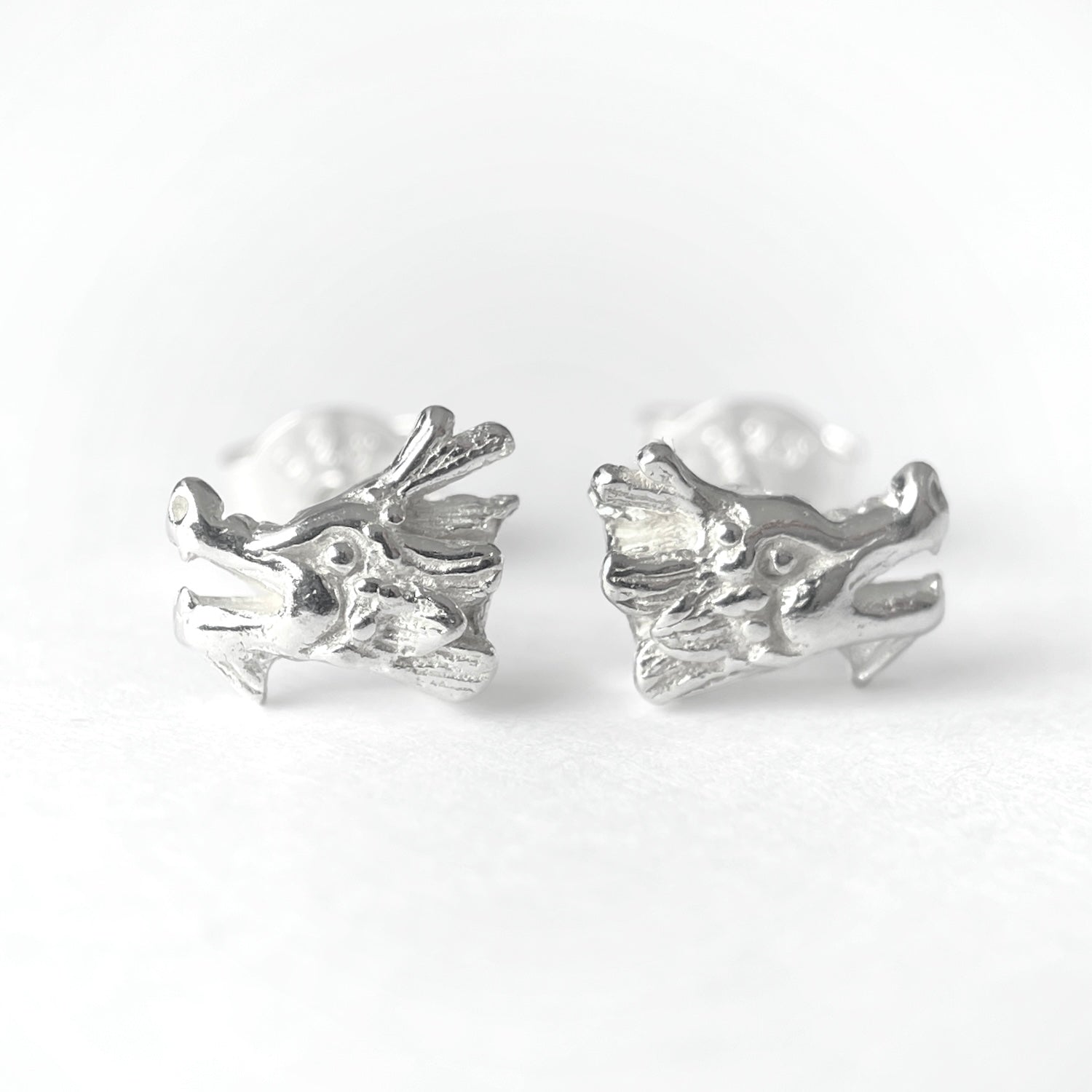 <div><em>Dragon Stud Earrings</em>: mini studs in sterling silver.</div> <div><span>&nbsp;</span></div> <div><span></span></div> <div>7 x 7 x 3 mm</div>