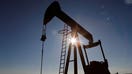 FILE PHOTO: The sun is seen behind a crude oil pump jack in the Permian Basin in Loving County, Texas, U.S., November 22, 2019. Picture taken November 22, 2019. REUTERS/Angus Mordant/File Photo

