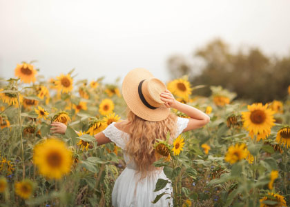 An ad of a woman in a sunflower field is being lifted out of the mobile screen on scroll