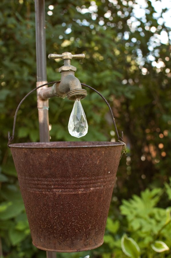 yard art...just a pipe and faucet from the hardware store, a crystal from the craft store, and an old bucket from the thrift shop.