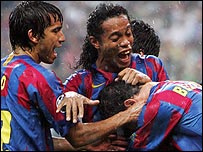 Van Bronckhorst (left) and Ronaldinho help Belletti celebrate his goal