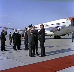 President John F. Kennedy speaks with Secretary of State, Dean Rusk and Military Aide to the President, General Chester V. Clifton, upon his arrival aboard Air Force One at Andrews Air Force Base, Maryland, following Easter vacation in Palm Beach, Florida., 27 April 1962