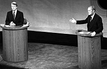 A monochrome picture of Carter and Ford, both standing at podiums during a debate.