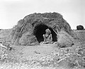 Image 57An Eastern Arrernte man of the Arltunga district, Northern Territory, in 1923. His hut is decked with porcupine grass. (from Aboriginal Australians)