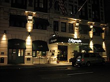 The Algonquin Hotel at night, with a large awning over the entrance, as well as spotlights on the facade and between the ground-story windows