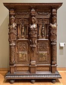Henry II style wardrobe; c. 1580; walnut and oak, partially gilded and painted; height: 2.06 m, width: 1.50 m, depth: 0.60 m[96]