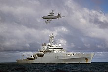 4-engined plane flies over ship