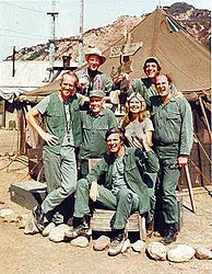 The cast of M*A*S*H from season 8 onward (clockwise from left): Mike Farrell, William Christopher, Jamie Farr, David Ogden Stiers, Loretta Swit, Alan Alda, and Harry Morgan