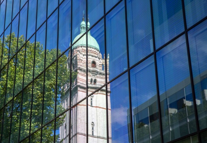 The Queen's Tower at Imperial College London seen in a reflection on a window.