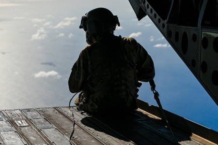 A U.S. Army flight engineer assigned to Bravo Company, 3rd Battalion, 25th General Support Aviation Brigade, flies in a CH-47 Chinook during military freefall training over Bellows Air Force Station, Hawaii, during Exercise Rim of the Pacific...