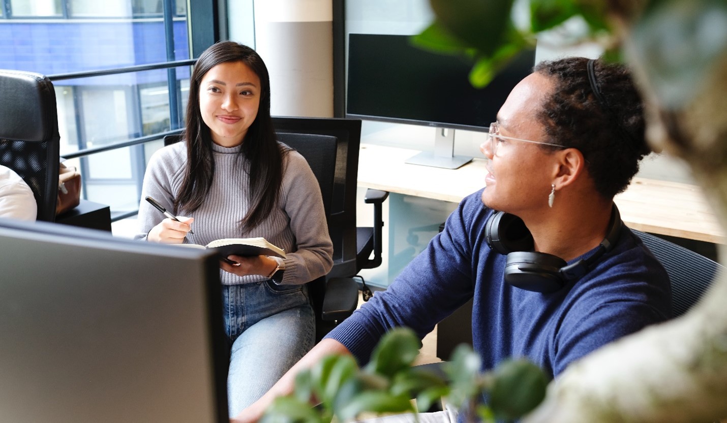 a man and a woman looking at a laptop