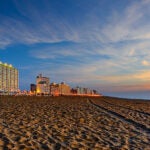 Shot taken about 20 minutes prior to sunrise. Looking up the beach. Black buyer condo