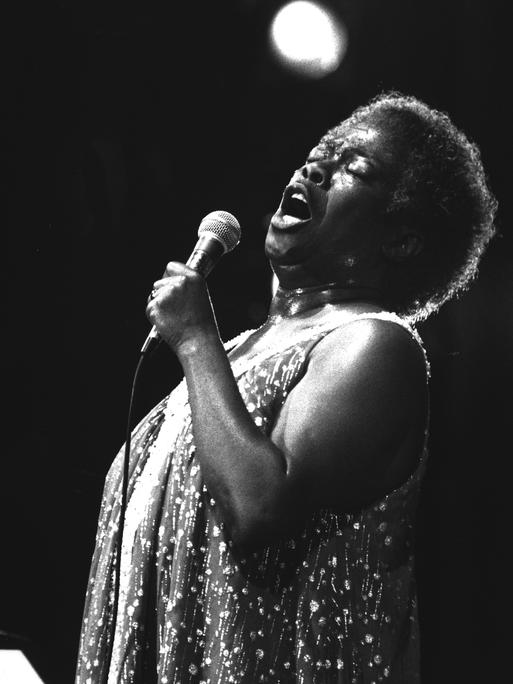 Schwarzweißfotografie von Sarah Vaughan, die auf der Bühne singt