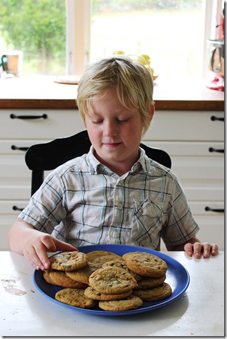 Sebastian hugger in på kakfatet, redo att smaka en nybakad kaka.