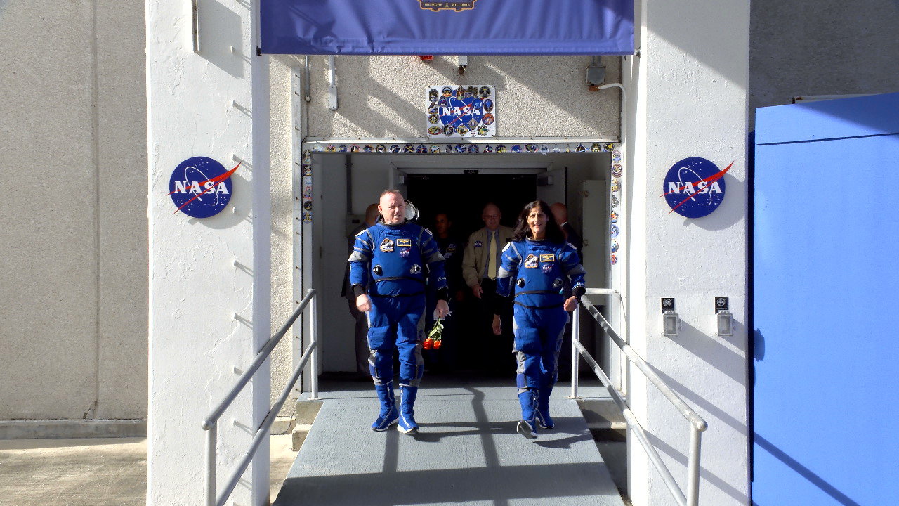 NASA Astronauts Butch Wilmore and Suni Williams walk out of Neil A. Armstrong Operations and Checkout Building on Saturday, June 1, 2024, at the agency’s Kennedy Space Center in Florida. 