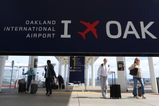 OAKLAND, CALIFORNIA - APRIL 12: Travelers walk towards Terminal 2 at Oakland International Airport on April 12, 2024 in Oakland, California. The Board of Commissioners for the Port of Oakland voted on Thursday to proceed with a plan to change the name of Oakland International Airport to the San Francisco Bay Oakland International Airport. San Francisco officials are objecting to the proposed name change and have threatened to file a lawsuit arguing it would violate the city’s trademark on San Francisco International Airport and would potentially be confusing for people traveling to the area. (Photo by Justin Sullivan/Getty Images)