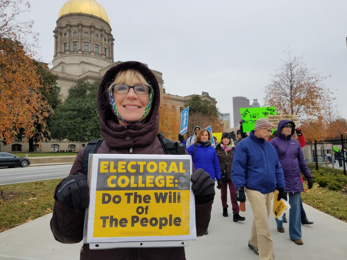 Connie Wernersbach demonstrates outside the meeting of Georgia's electors in Atlanta.