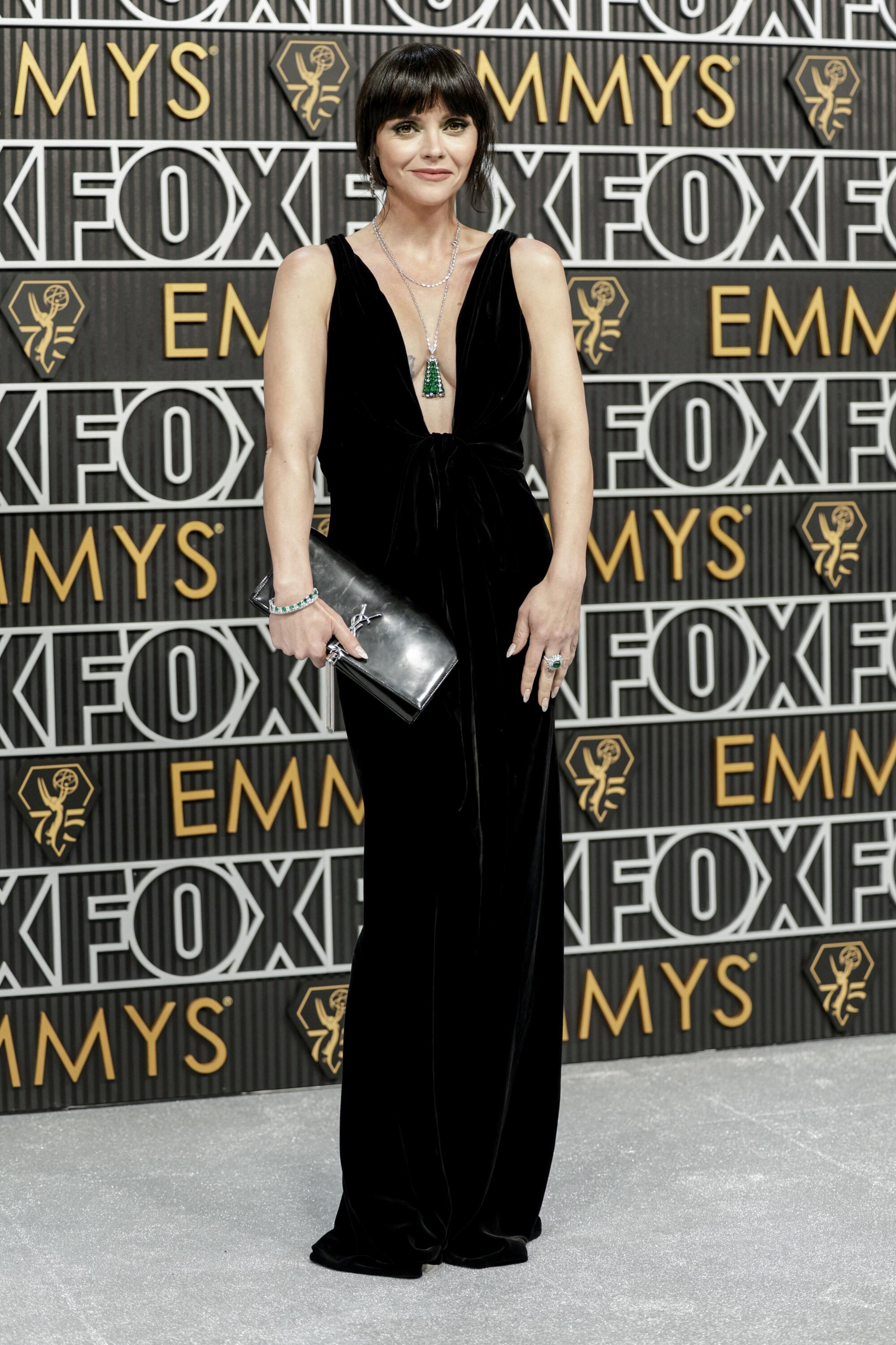 Christina Ricci wears a black dress on the Emmys red carpet. 