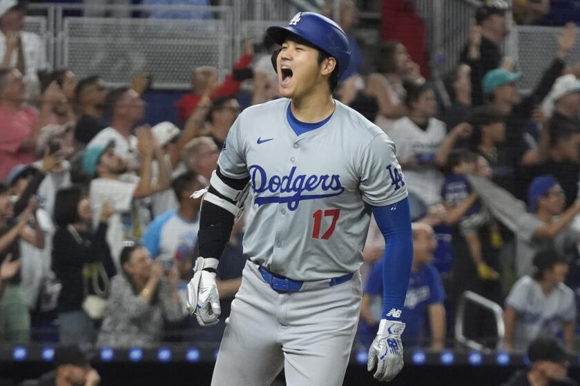 Los Angeles Dodgers' Shohei Ohtani (17) reacts after hitting his 50th home run.