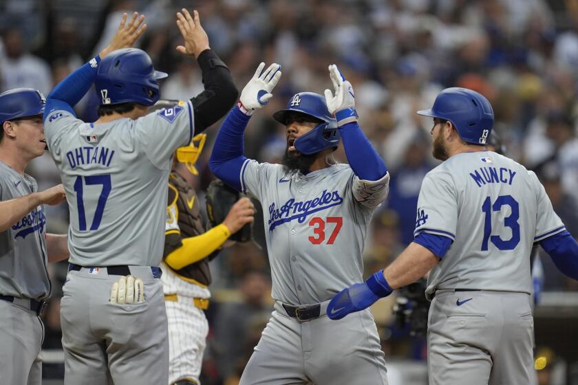 The Dodgers' Teoscar Hernández celebrates with Will Smith, Shohei Ohtani and Max Muncy after hitting a grand slam