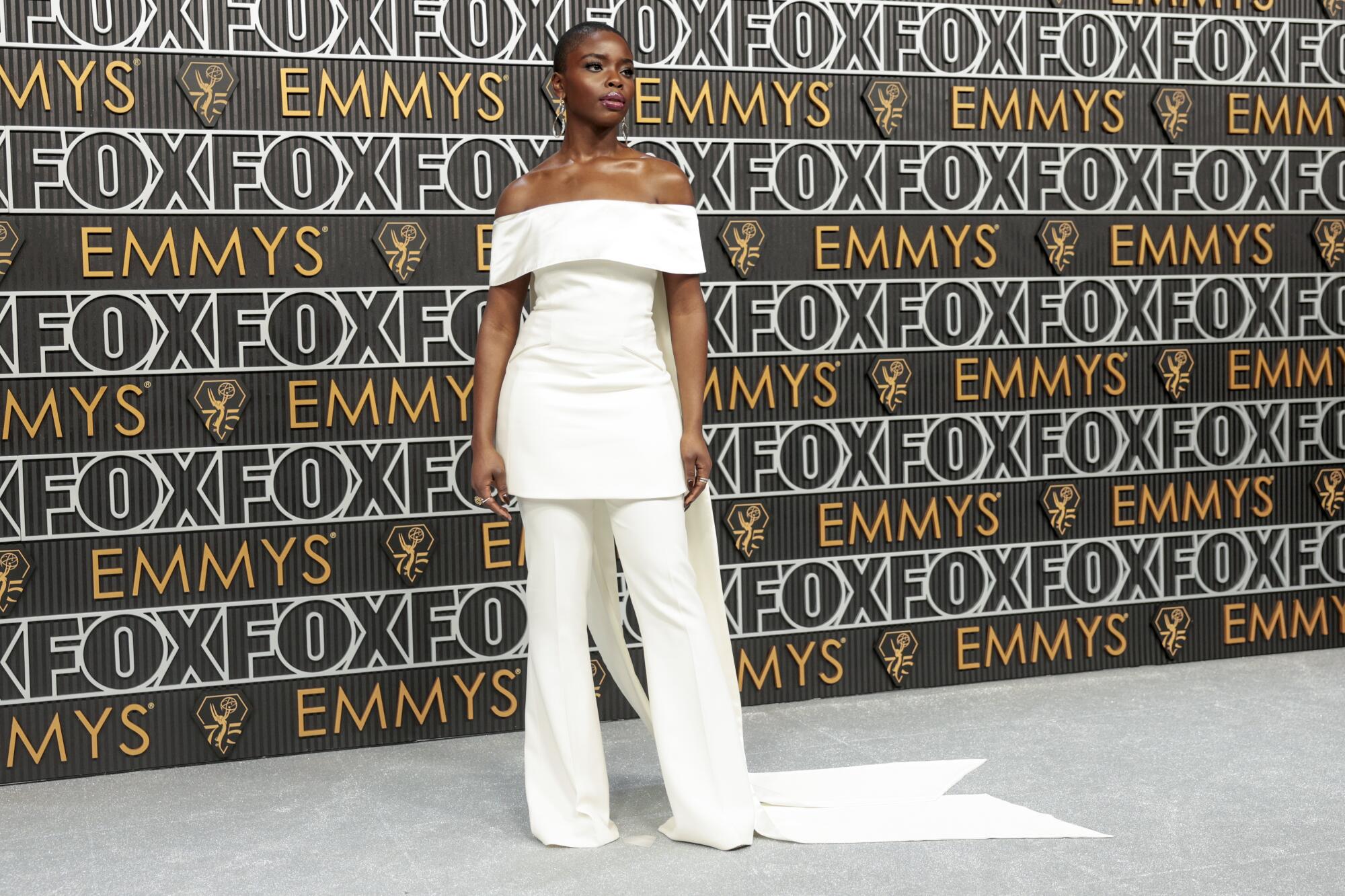 Joy Sunday wears a white pant suit on the Emmys red carpet. 