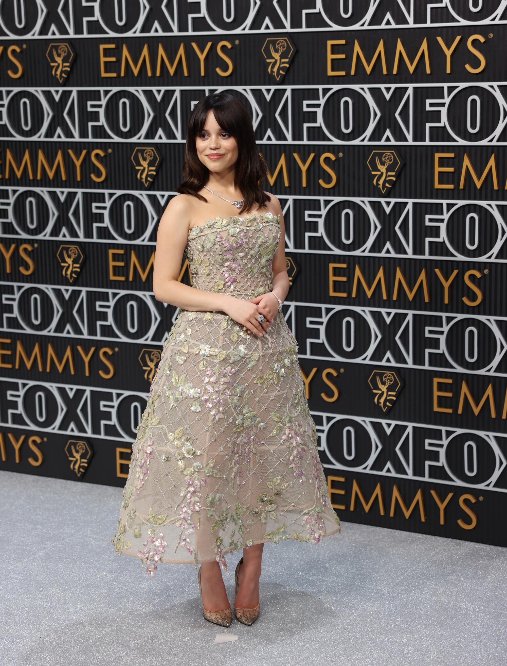 Jenna Ortega poses on the Emmys red carpet. 