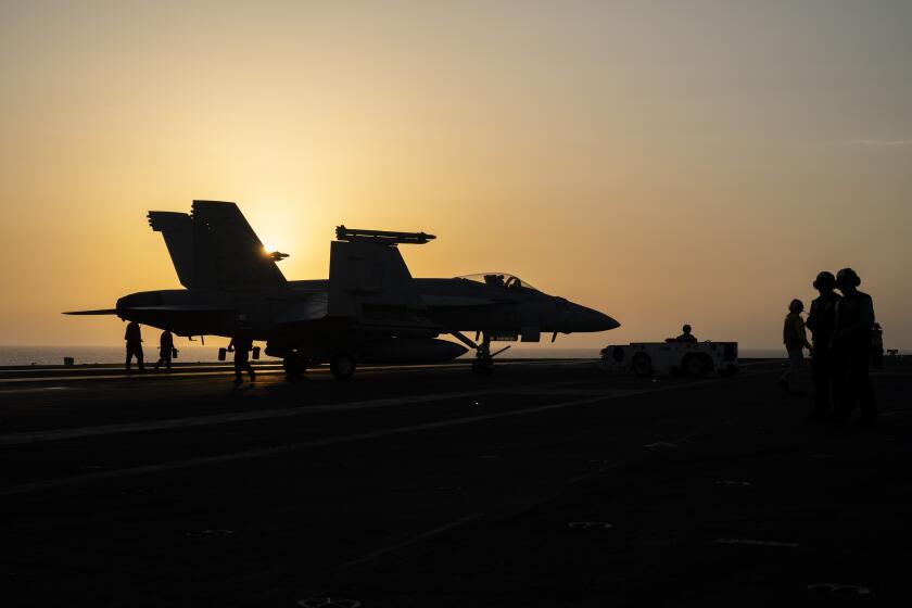 A fighter jet parks on the deck of the USS aircraft carrier Dwight D. Eisenhower, also known as 'IKE', in the Red Sea, Tuesday, June 11, 2024. (AP Photo/Bernat Armangue)