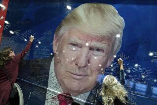 Supporters of Republican presidential candidate former President Donald Trump sign a campaign bus during the Conservative Political Action Conference, CPAC 2024, at the National Harbor in Oxon Hill, Md., Thursday, Feb. 22, 2024. (AP Photo/Jose Luis Magana)