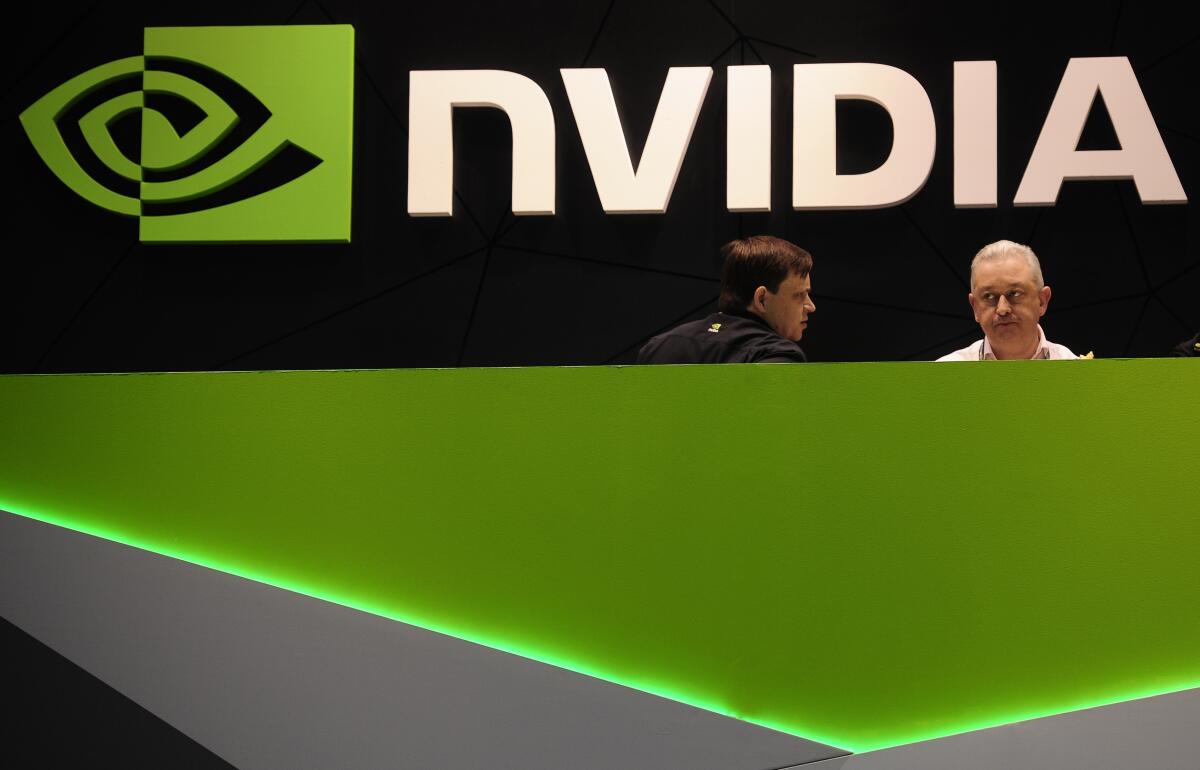 People gather in the Nvidia booth at the Mobile World Congress mobile phone trade show 