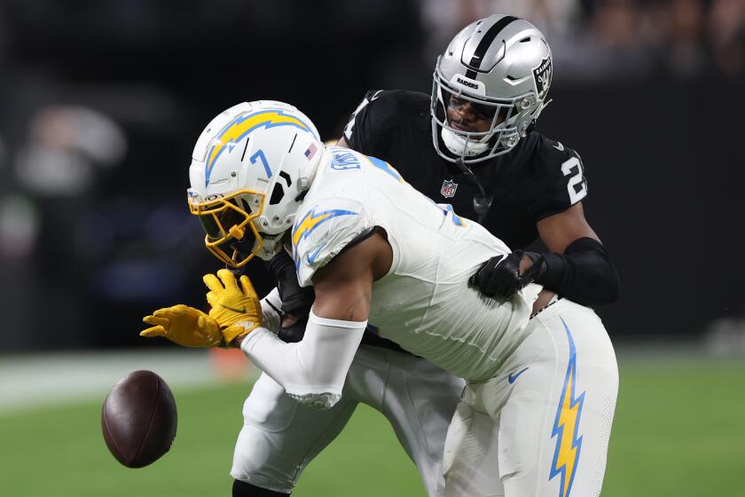 LAS VEGAS, NEVADA - DECEMBER 14: Cornerback Amik Robertson #21 of the Las Vegas Raiders breaks up a pass intended for tight end Gerald Everett #7 of the Los Angeles Chargers during the second quarter at Allegiant Stadium on December 14, 2023 in Las Vegas, Nevada. (Photo by Sean M. Haffey/Getty Images)