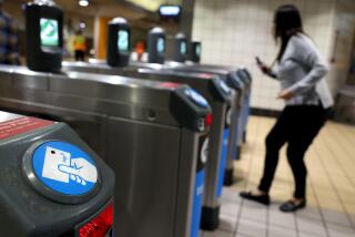 NORTH HOLLYWOOD, CALIFORNIA May 29, 2024- A rider taps her card to gain entry to the train at the Metro North Hollywood station Wednesday. (Wally Skalij/Los Angeles Times)