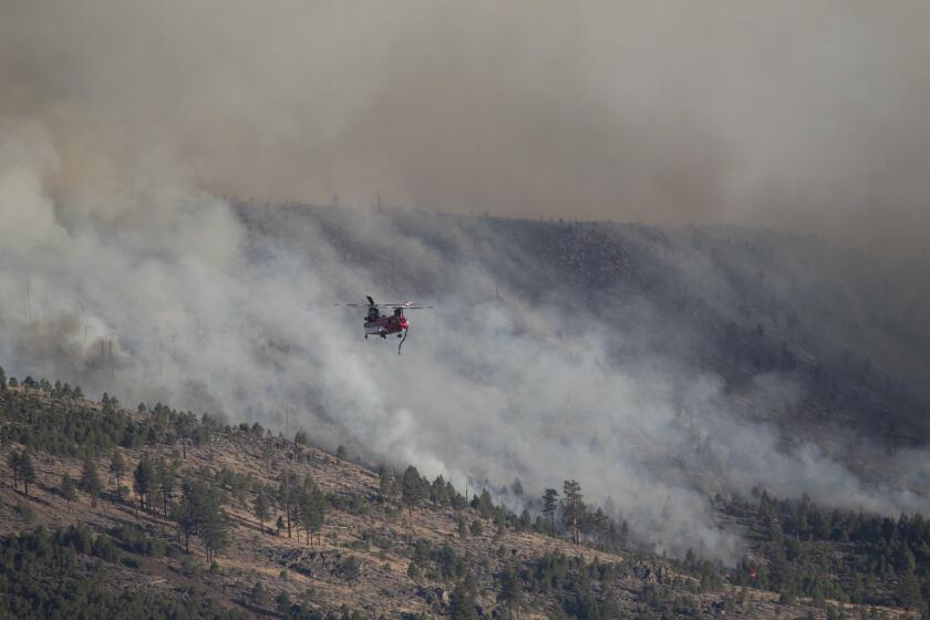 Fire crews work to contain the fast moving Bear fire that started near the town of Loyalton and Sierraville, California.