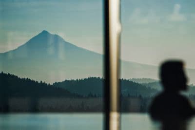 A man relaxes in an indoor infinity pool 