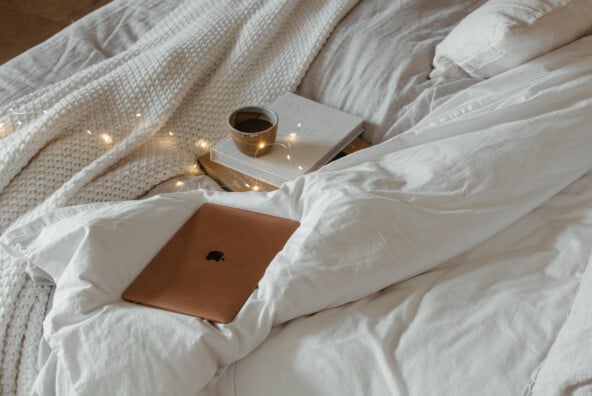 laptop on cozy bed