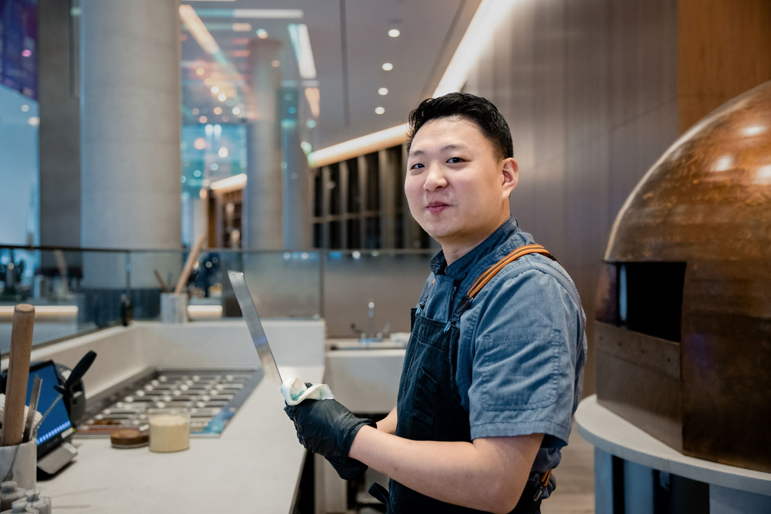 Chef looking at camera holding large knife