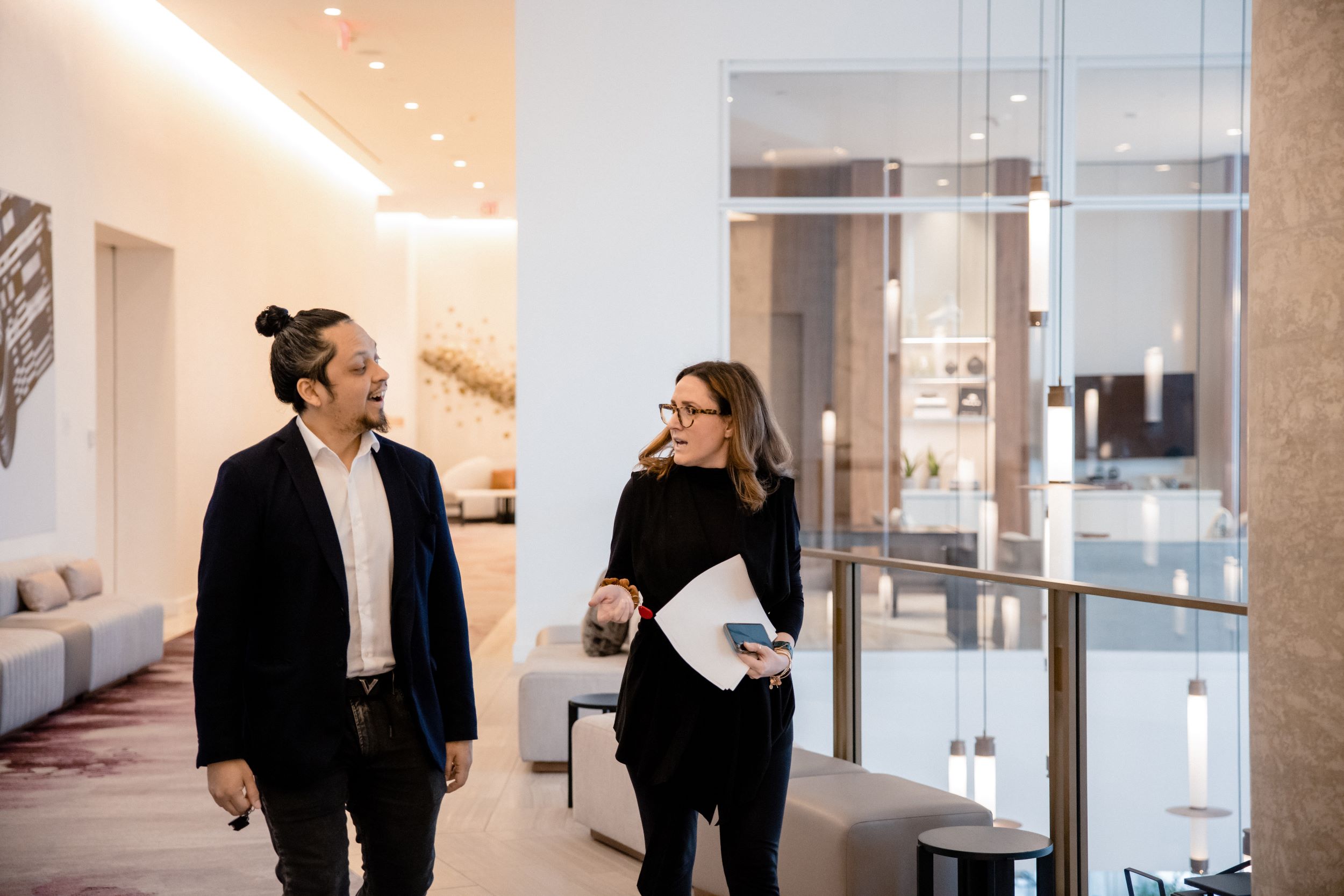 Two associates walking down a hall chatting