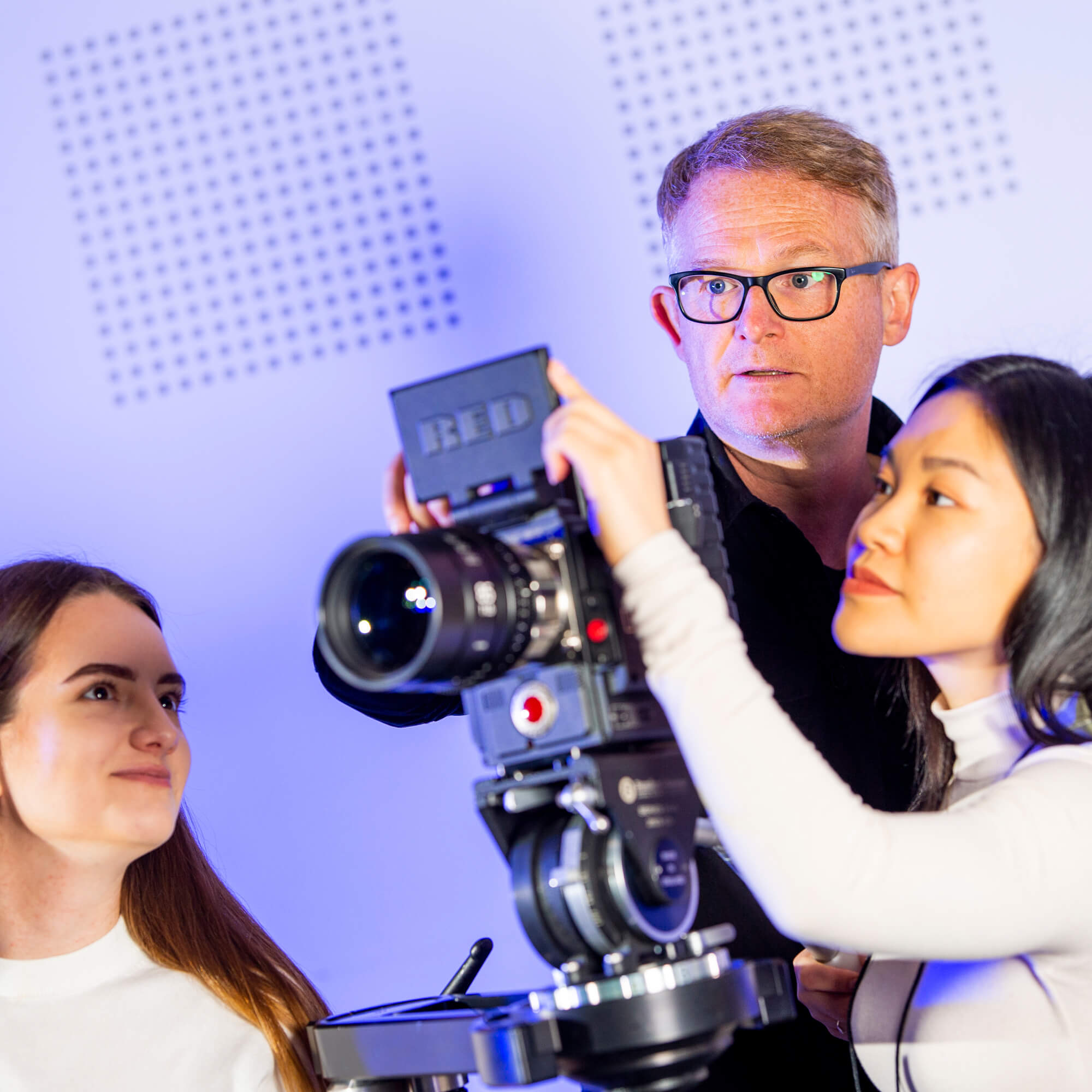 Students looking into a production camera