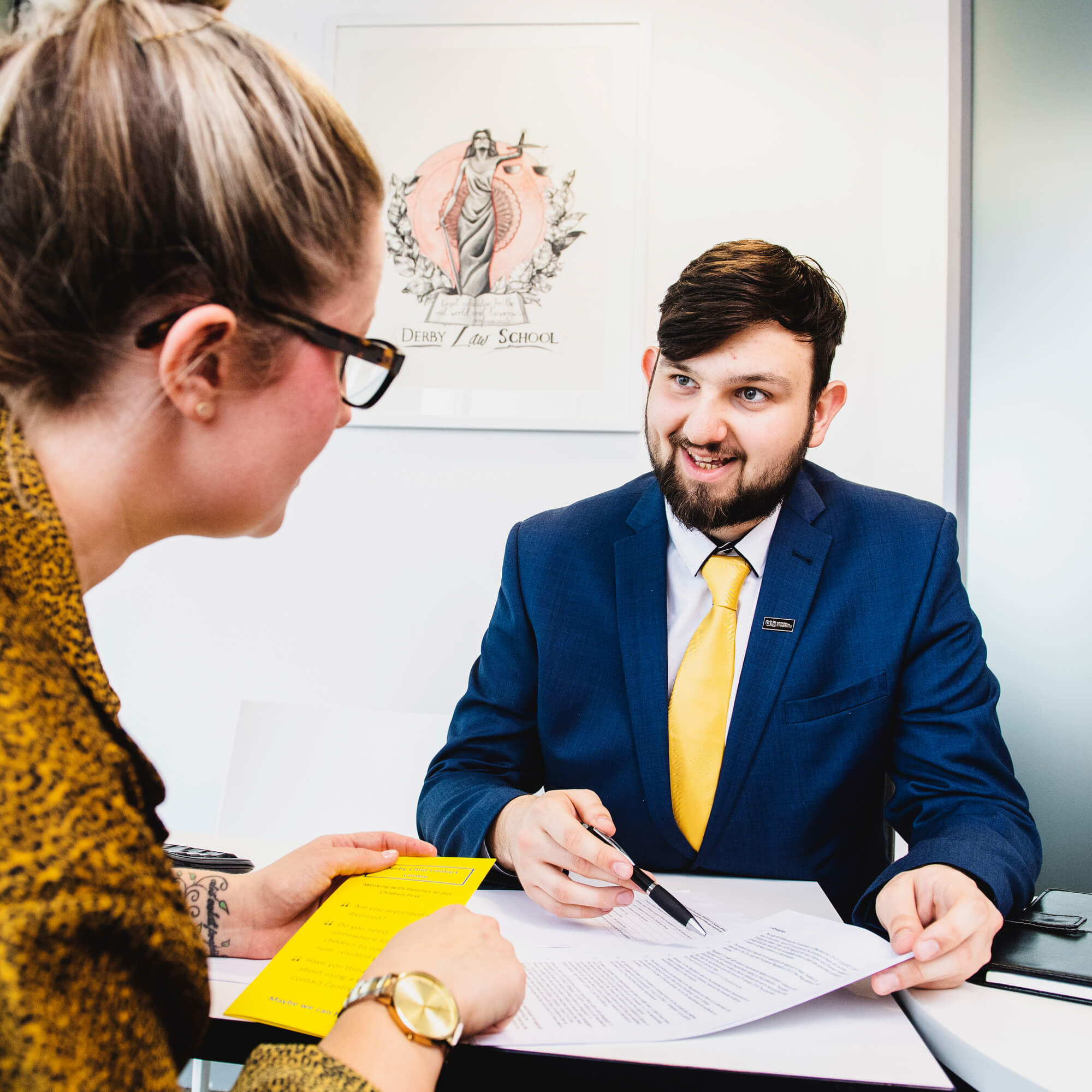 Solicitor talking over paperwork with client