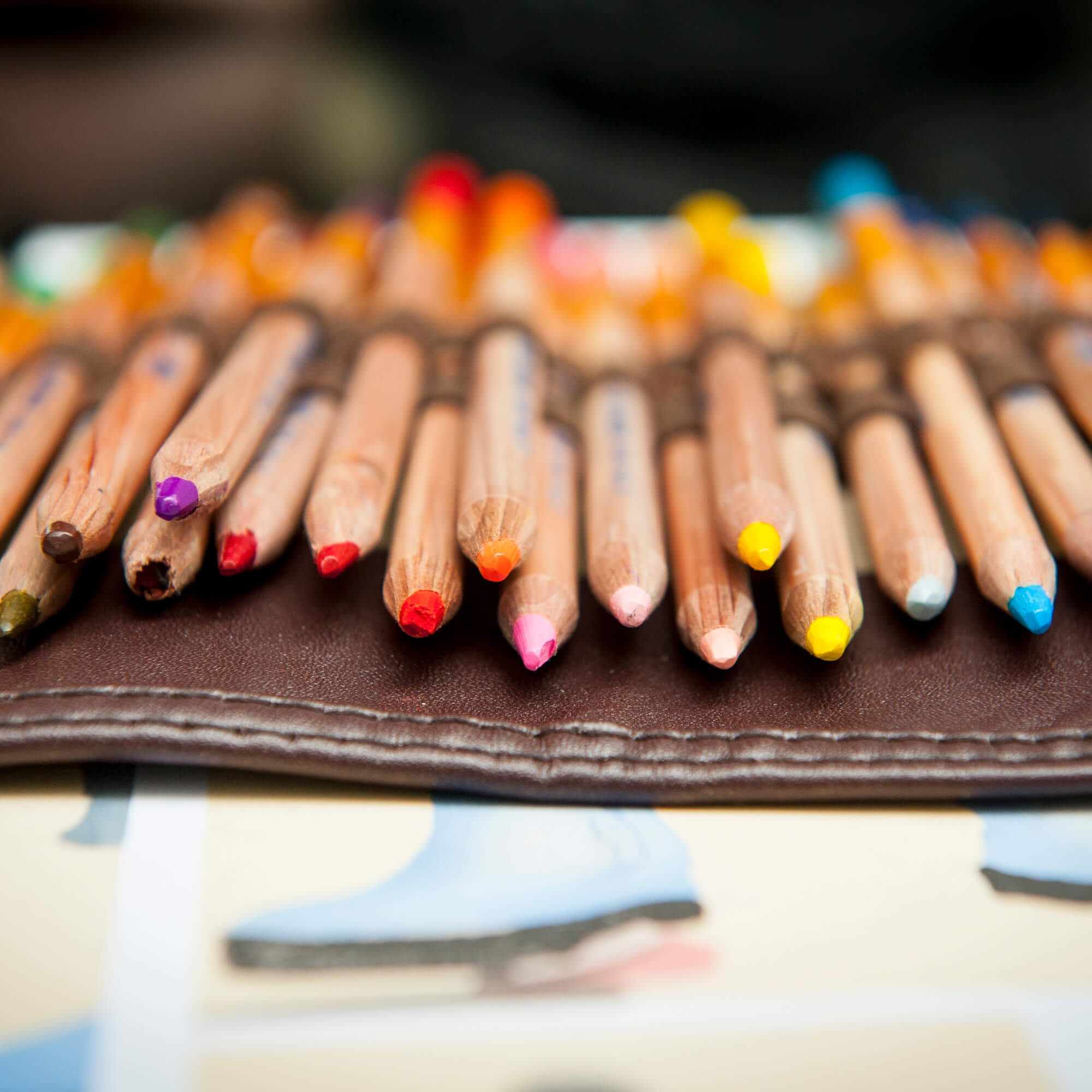 Multiple coloured crayons sat on top of each other