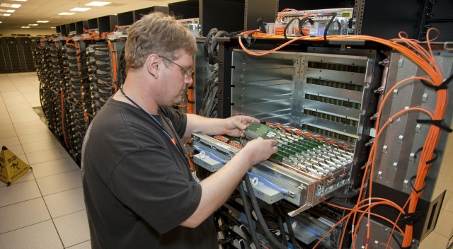 An IBM technician loads CPUs into Sequoia, the world's fastest supercomputer.