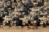 Израильские солдаты играют в футбол возле танков и бронетранспортеров недалеко от границы Израиля и Газы.