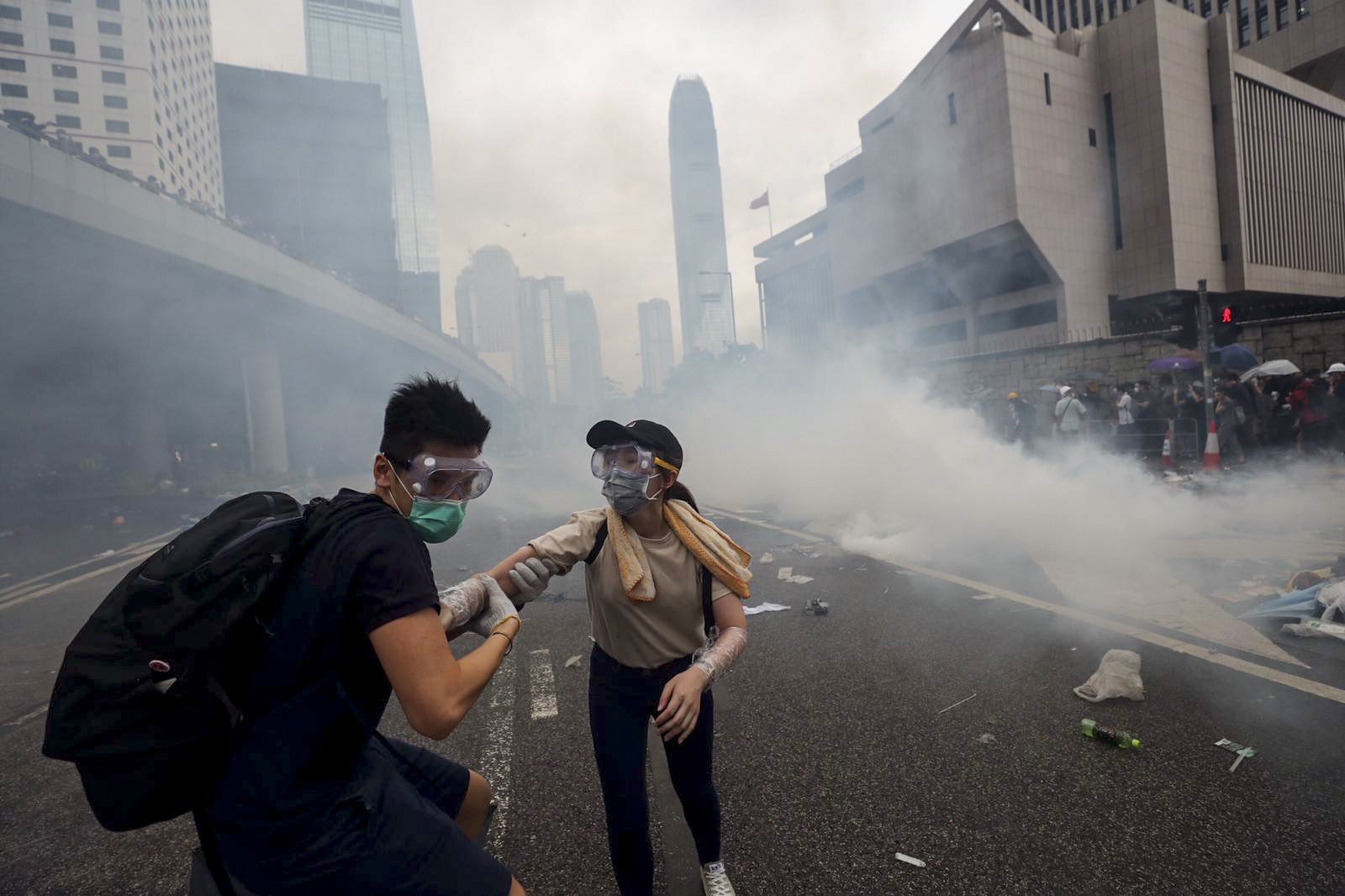 Anti-extradition bill protesters run away from a cloud of tear gas fired by Hong Kong police during protests on June 12. Photo: Sam Tsang