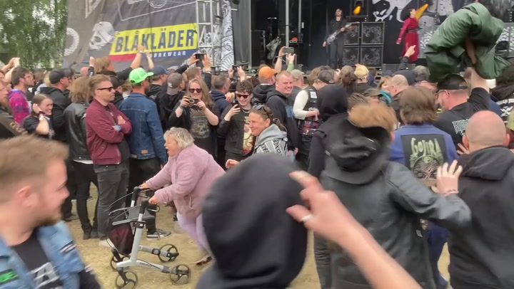 Elderly fan with walker leads mosh pit at heavy metal festival