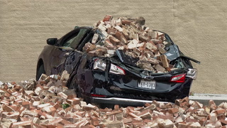 Car crushed by fallen bricks as deadly thunderstorm causes damage