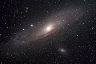 Space image of disk-shaped Andromeda galaxy seen from side